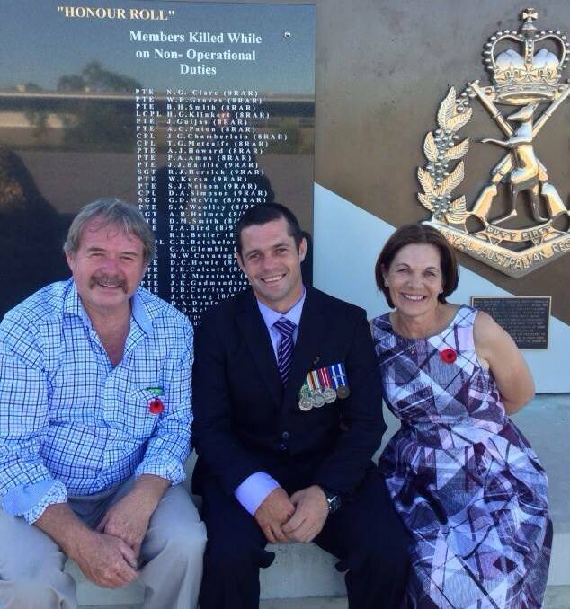 FAMILY SUPPORT: Corporal Ben Duffy (centre) with parents Kevin and Sandra in Brisbane. Photo: Supplied