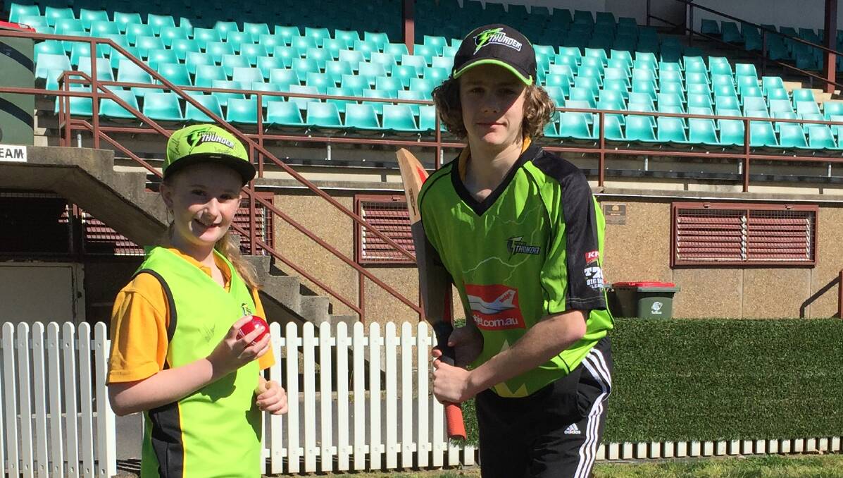 THUNDERSTRUCK: Sydney Thunder fans Haylee Kennedy, 9, and Alex Wiegold, 15, from Orange at Wade Park. Photo: DAVID FITZSIMONS