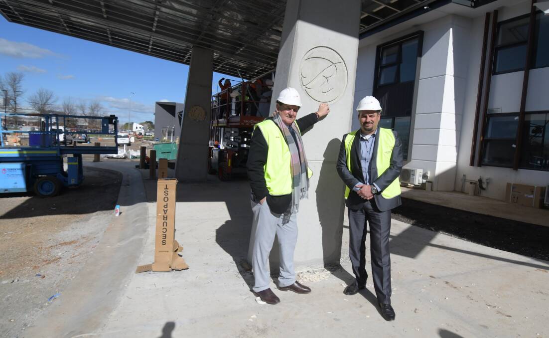 NEARLY READY: Orange mayor Reg Kidd and The Remington group manager Grant Gill outside the new hotel on Forest Road. Photo: JUDE KEOGH