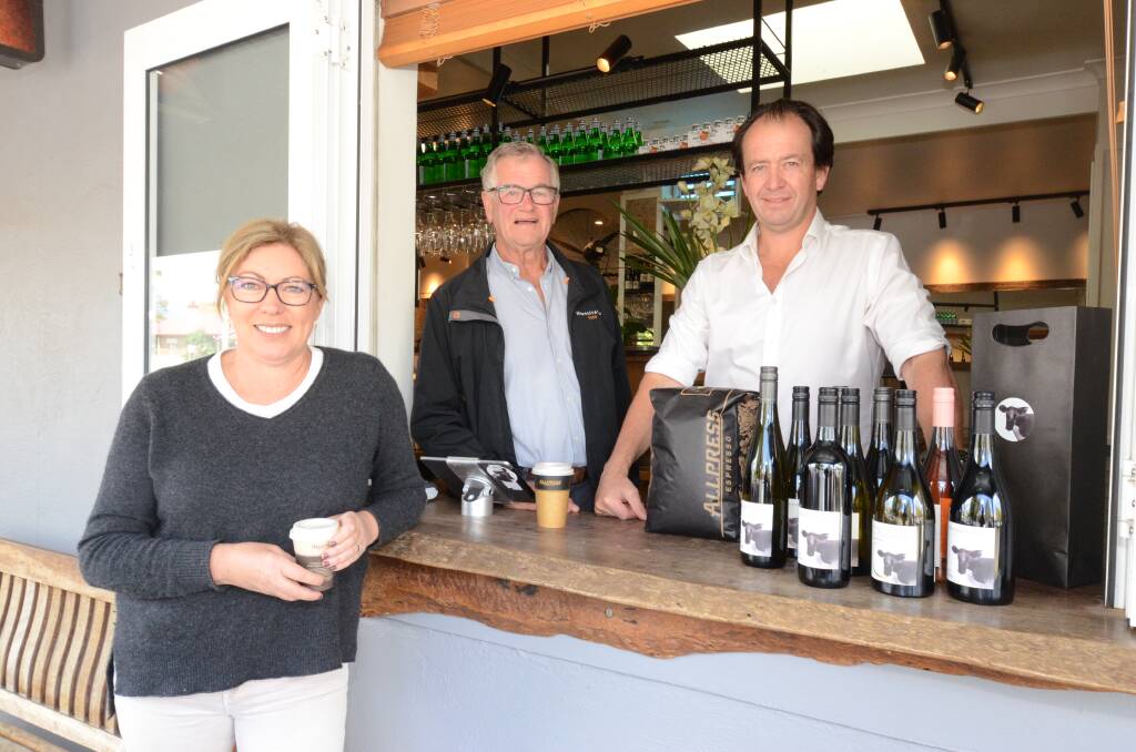 TOGETHER: Michelle and Phillip Stivens with Jeremy Norris at the Byng Street Cafe and Local Store's new window. Photo: JUDE KEOGH