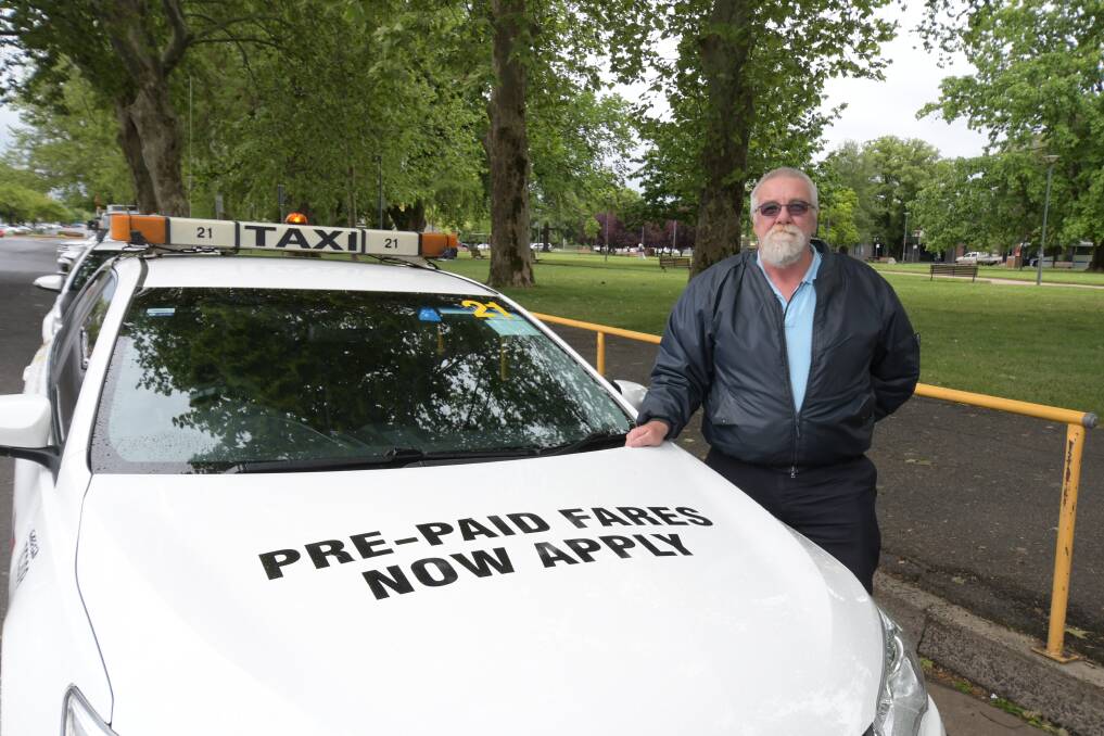 DRIVER: Richard Burke with one of the cabs displaying the pre-paid message. Photo: CARLA FREEDMAN