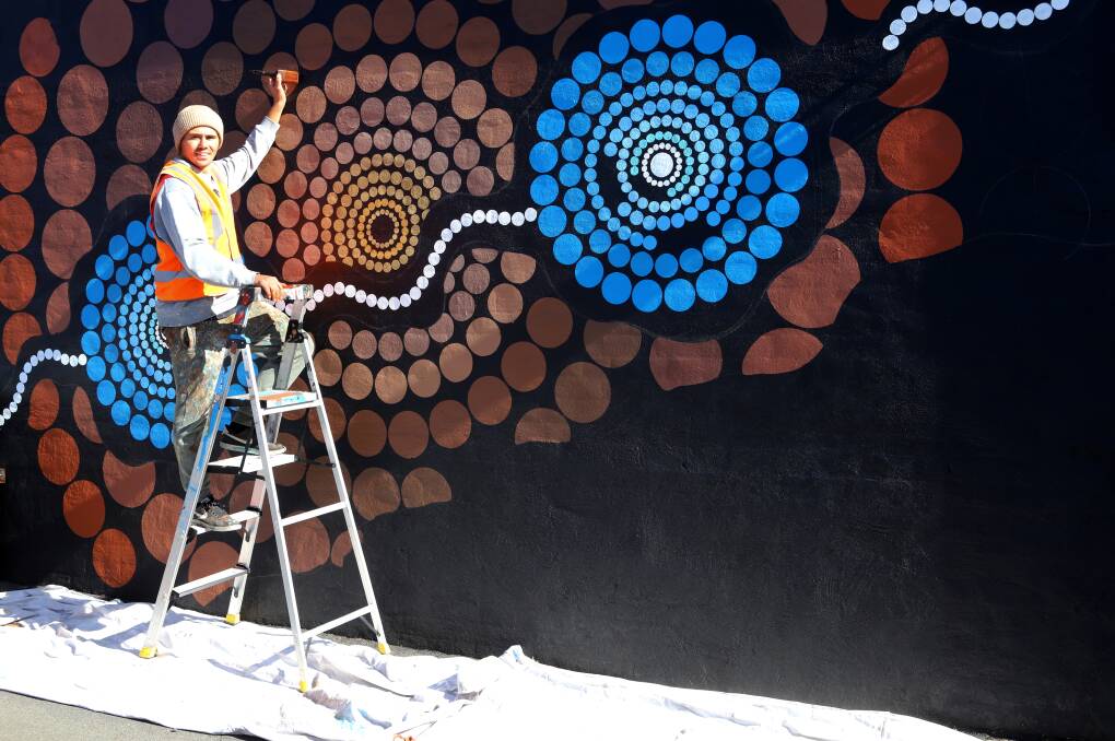 NEARLY DONE: Artist Sandon Gibbs-O'Neill works on his street art project on Sunday. Photo: CARLA FREEDMAN