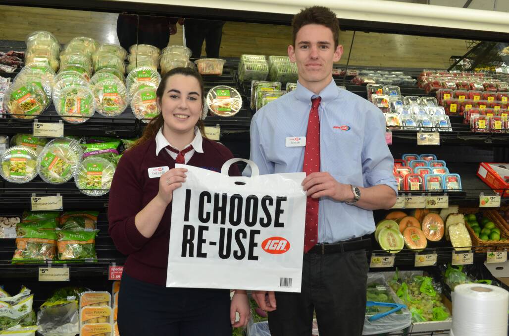 GET THE MESSAGE: IGA workers Therese Blizzard and Ciaran Etty with one of the options to one-use plastic bags. Photo: DAVID FITZSIMONS 0415dfbag3