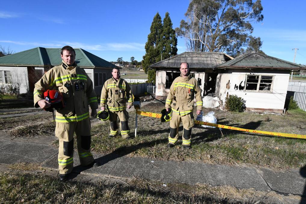 KEPT BUSY: Station officer Brad Monico, senior firefighter Mitch Crump and leading firefighter Andrew Webb at the Maxwell Avenue fire site. Photo: JUDE KEOGH 0703jkhousefire1
