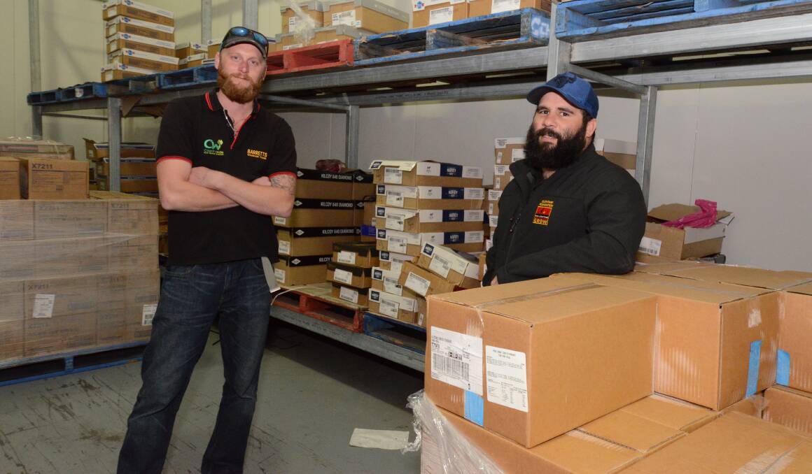BOXES OF FOOD: Chris Davis from Barrett's and Tom Goolagong from the Clontarf Foundation with some frozen goods. Photo: JUDE KEOGH