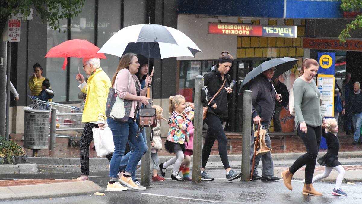 GLORIOUS RAIN: Shoppers dusted off their umbrellas and headed out as the rain fell on Summer Street on Thursday. Photo: JUDE KEOGH