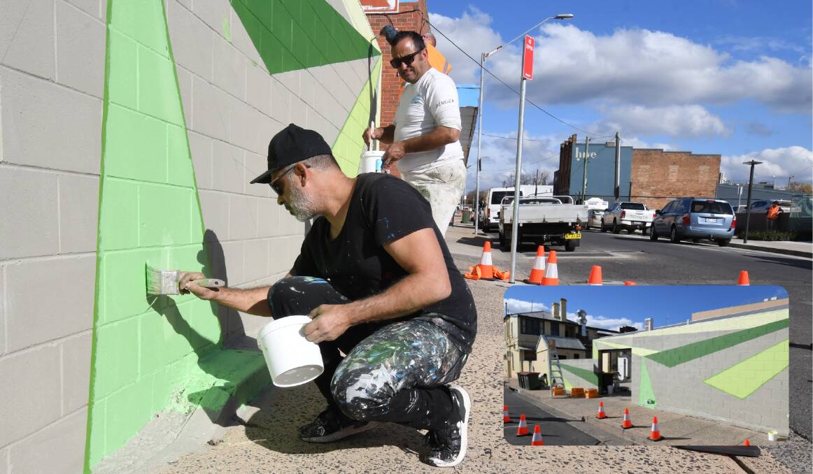 ARTY: Yanni Pounartzis and Jacob Bing paint a McNamara Street wall in shades of green for the art work Vineyards (inset). Photos: JUDE KEOGH