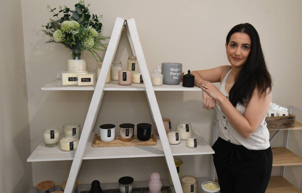 ONLINE MARKET: Lina Zappia with some of the handmade candles she will be selling as part of the online markets this weekend. Photo: JUDE KEOGH