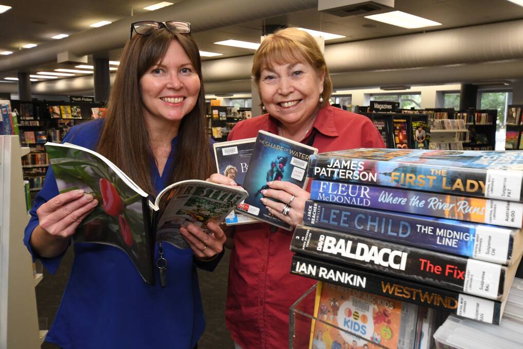 EAGER READERS: Librarians Therese Kostitch and Lyn Bugden with Orange's top reads and DVDs of 2019. Photo: JUDE KEOGH