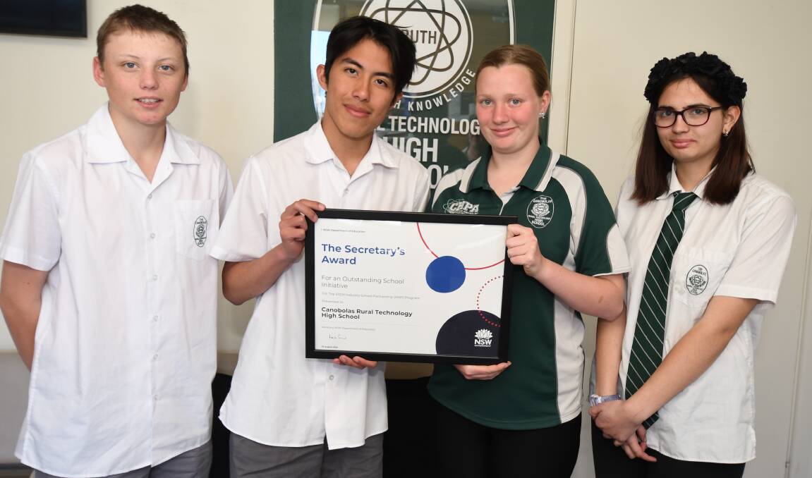 STUDENTS: Mark Selmes, Blair Bella, Jessica Healey and Isabelle Kent with the school's award. Photo: JUDE KEOGH