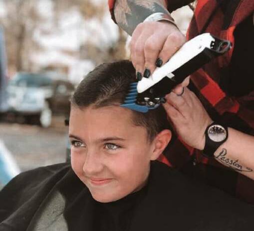 THE MOMENT: Ella's hair being shaved off last year at Wade Park. Photo: Supplied