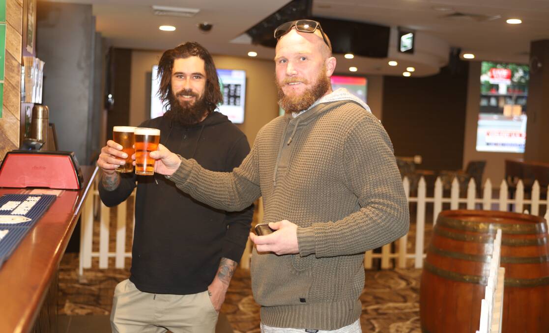 CHEERS: Anthony Dargin and Eric Stewart celebrate the re-opening of the club. Photo: CARLA FREEDMAN