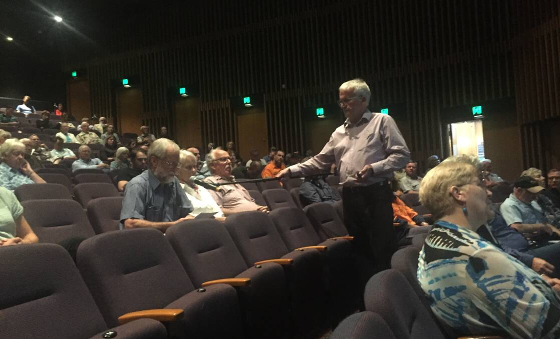 QUESTION TIME: Part of the socially-distanced crowd in the theatre as council officer Allan Reeder enables people to ask questions with a portable microphone.