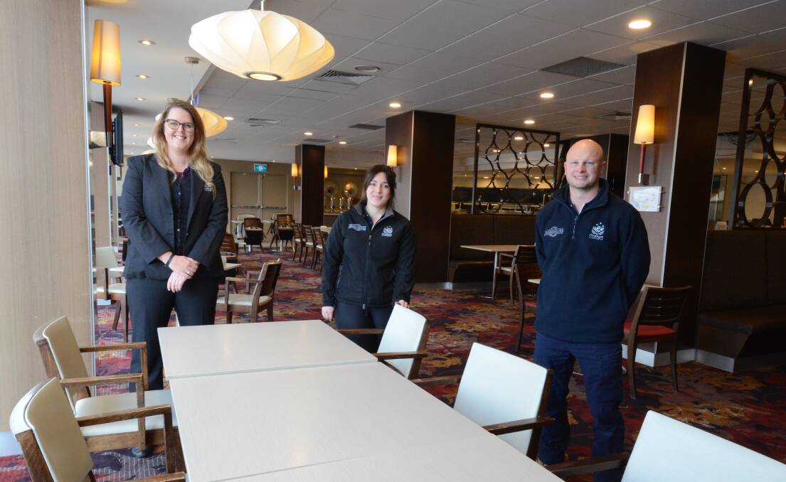 BACK ON DECK: Club staff Tayla Harvey, Kerry Crockett and Michael Rudd in the OESC's Diggers restaurant which is being altered to meet COVID-19 social distancing restrictions. Photo: JUDE KEOGH