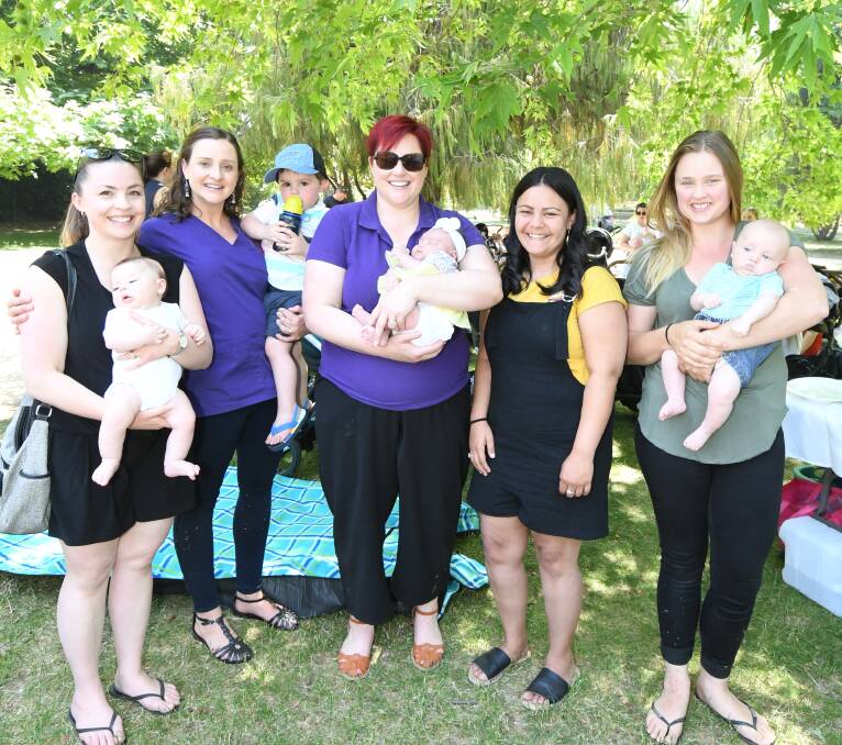 PARTY DAY: Group practice midwives with mums and baby in Cook Park, Ellen and Will Robbins, Elide Newton, Ben Robbins, Emma Kingham, Elyniyah and Sharni Dixon and Krystal Mitchell with Austen Hausler. Photo: JUDE KEOGH 1125jkmidwives2