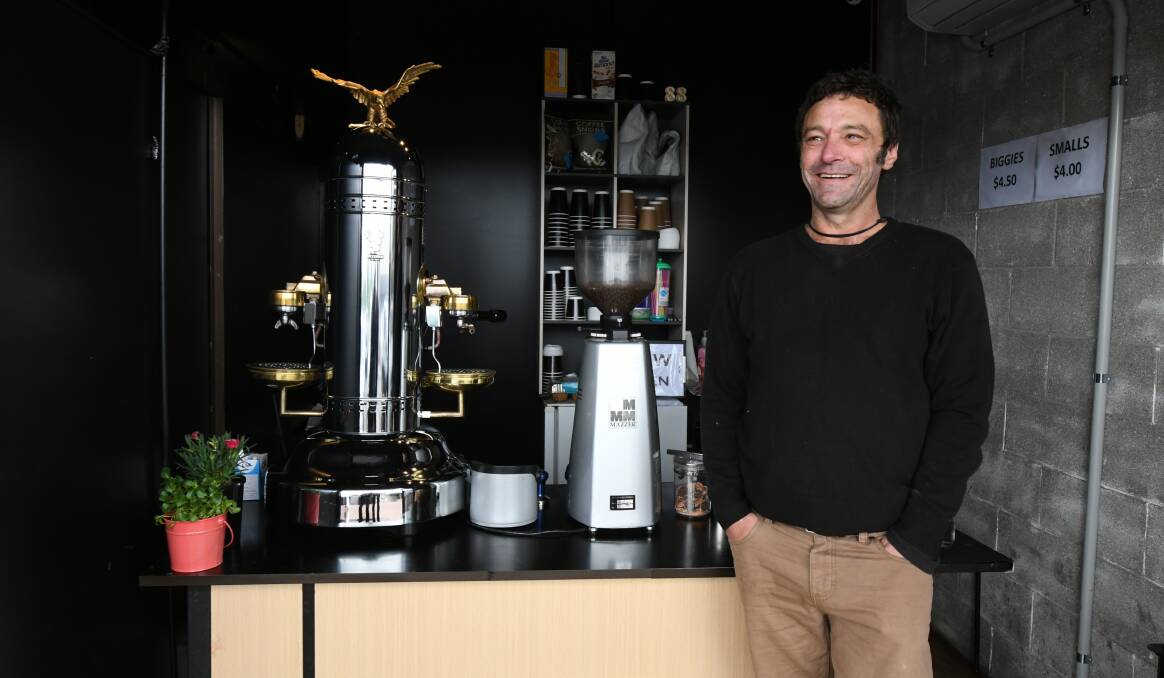 HOLE IN THE WALL: Jason Battle with his elaborate coffee machine. Photo: JUDE KEOGH 2311jkcoffee1