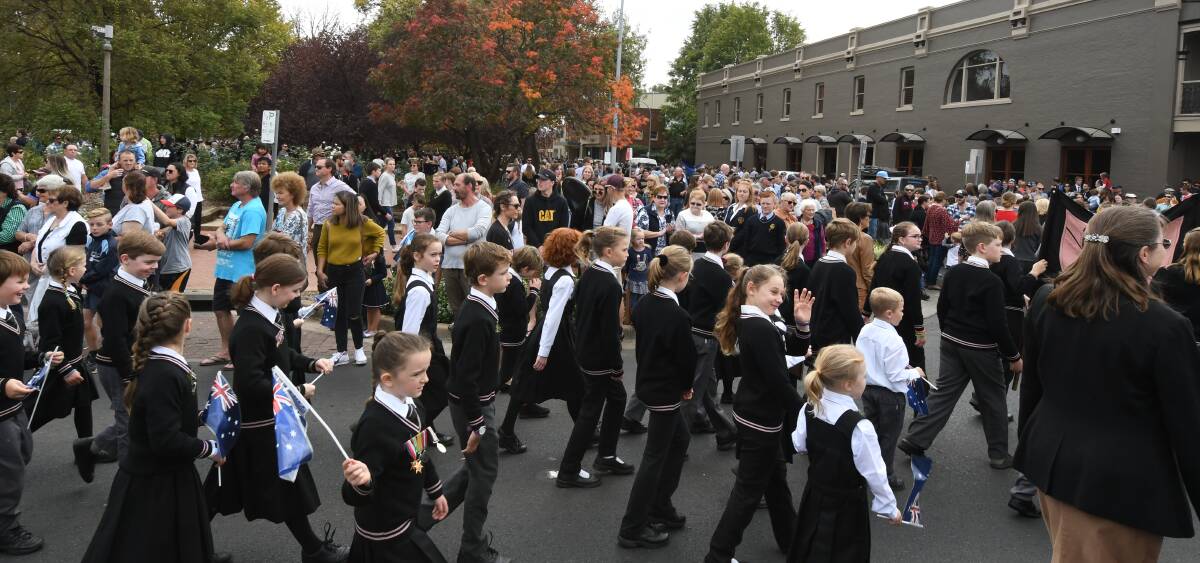 THE WAY WE WERE: Plenty of schoolchildren marching and crowds on the kerbside, as seen at Anzac Day 2019, will not be present on Sunday. Photo: CARLA FREEDMAN