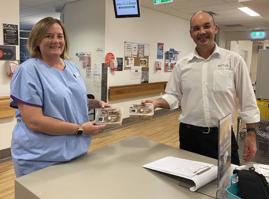 FOOD FOR STAFF: Nurse Trisha Hansen with Scott Turner from Delish Catering with meals being donated for hospital staff by Newcrest Cadia. Photo: Supplied