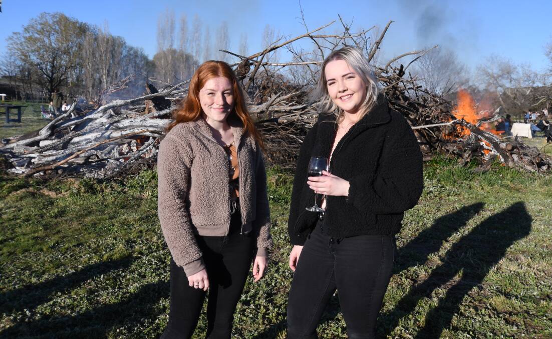 FIRE TIME: Jessica and Emily Cole at Heifer Station Wines as the bonfire warms up. Photo: CARLA FREEDMAN