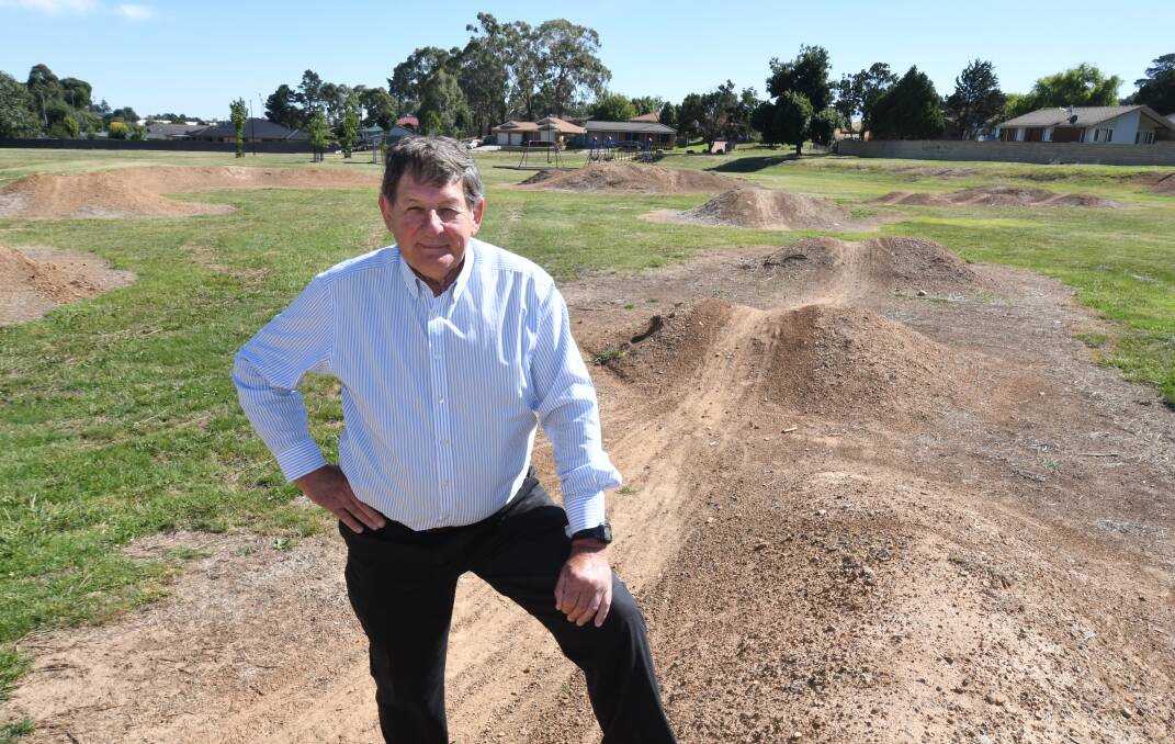 PUT TO GOOD USE: Orange mayor Reg kidd on the piles of dirt that have been shaped into a BMX track at Glenroi Oval. Photo: JUDE KEOGH
