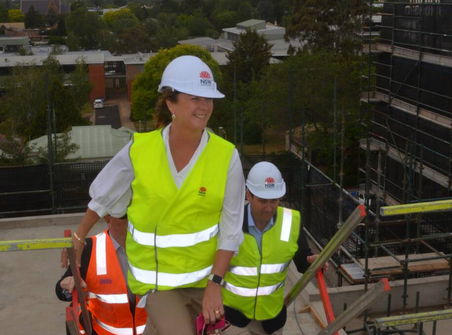 NEW VIEW: Minister for Water Melinda Pavey climbs to the top of the Department of Primary Industries building site in Prince Street before announcing the water funding. Photo: DAVID FITZSIMONS