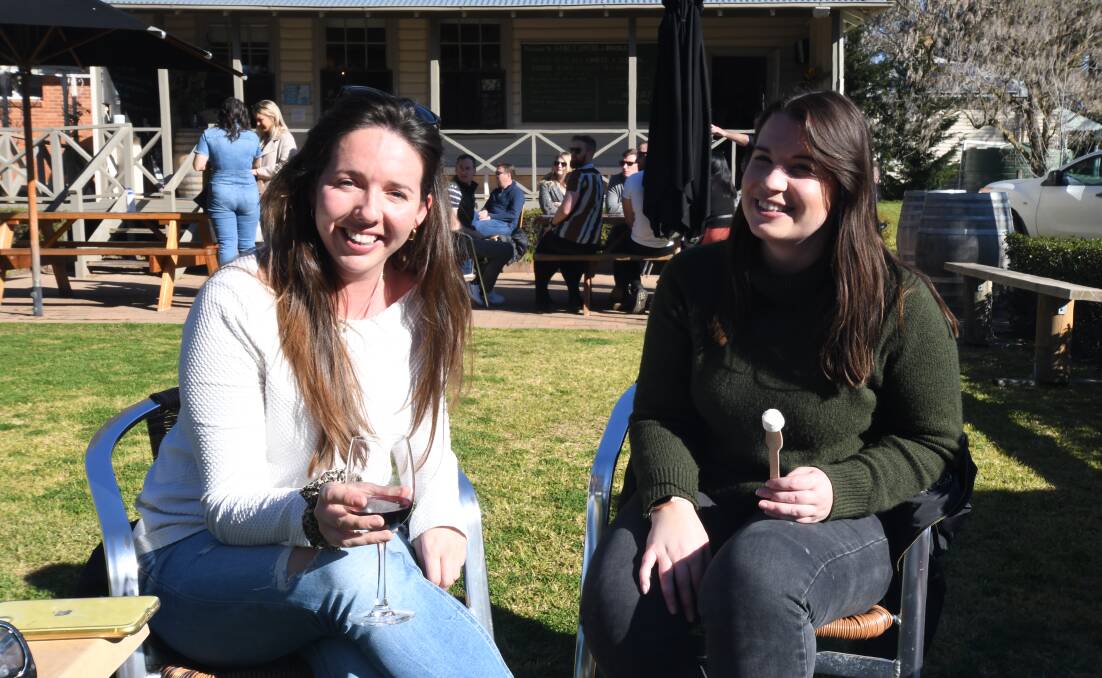 FESTIVAL FUN: Verity Parson and Steph Gray enjoy the sunshine at Mortimers Winery during the Winter Fire Festival on Saturday. Photo: CARLA FREEDMAN