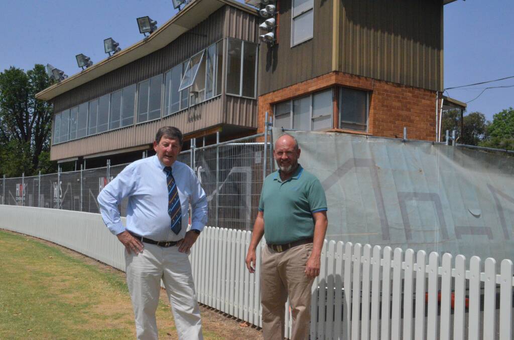 COMING DOWN: Councillors Reg Kidd and Jason Hamling in front of the buildings to make way for the indoor cricket centre. Photo: DAVID FITZSIMONS