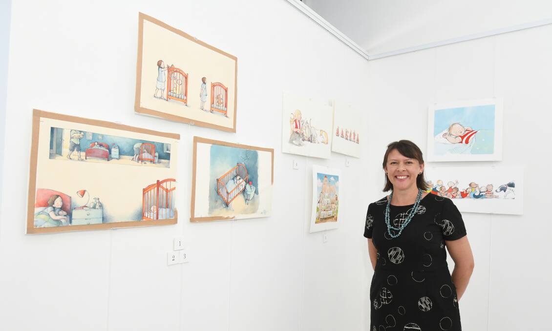 ON SALE: Illustrator Freya Blackwood with some of her works on sale at the Once Upon a Picture Book exhibition. Photo: JUDE KEOGH 0122jkfreya1