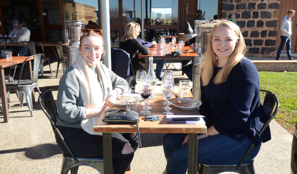 TASTING TIME: Ashleigh Livingston and Stacey Harrison enjoy an outdoor tasting at the busy Philip Shaw Wines cellar door . Photo: JUDE KEOGH