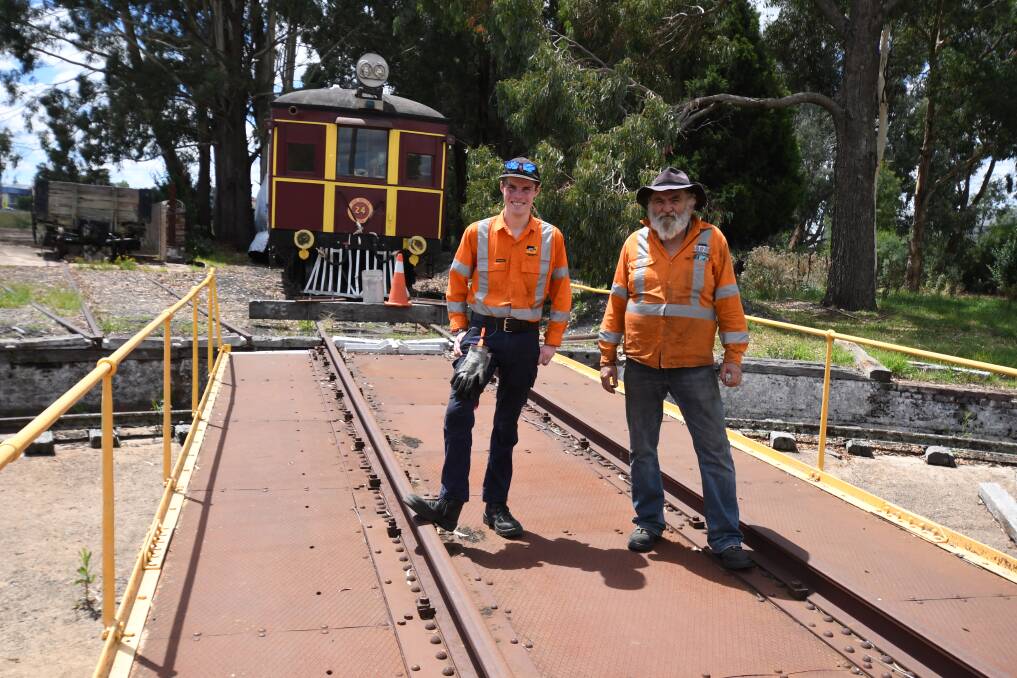 NEW HOME: LVR workers Fred Duncan and Michael Bond on the turntable at Orange East Fork with the trains. Photo: JUDE KEOGH
