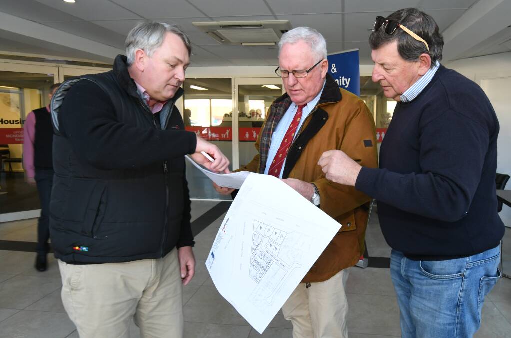 PLANS: David Fisher, Rick Colless and Cr Reg Kidd examine details for the proposed domestic violence accommodation refuge. Photo: JUDE KEOGH 0518jkhousing3