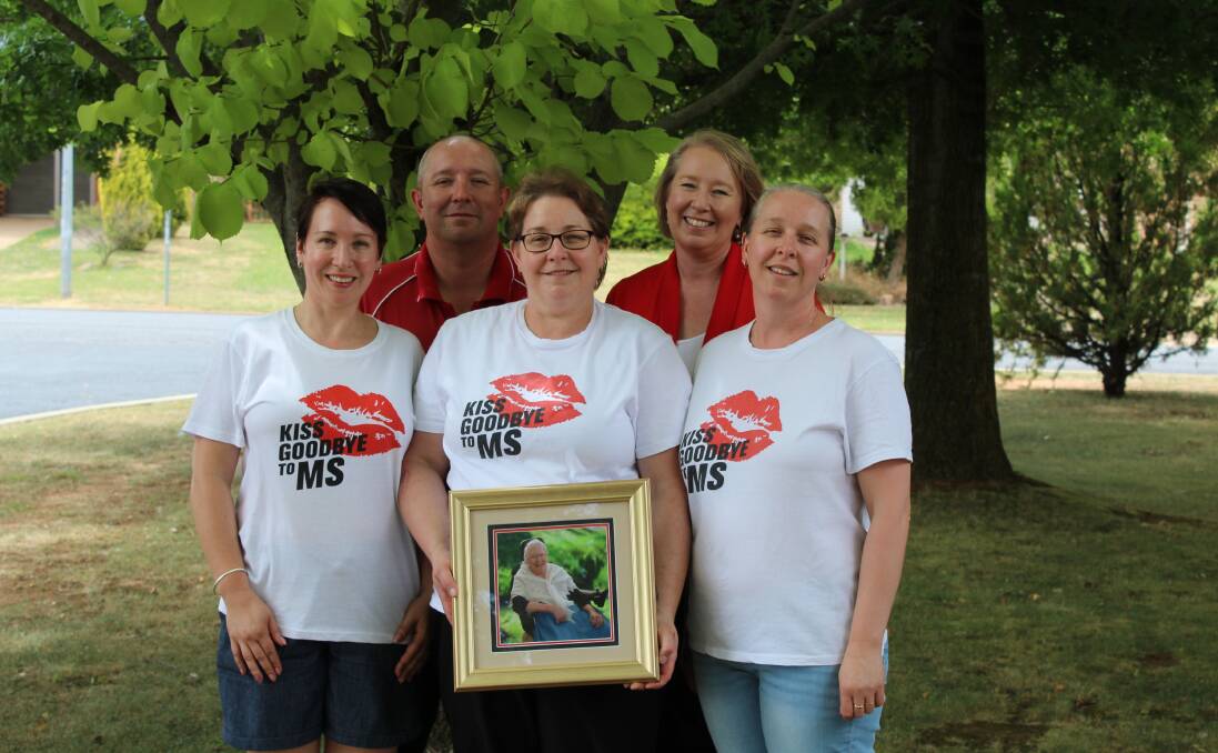 FAMILY VALUES: The Boltons, Samantha, Nick, Kerrin, Wendy and Jillian, with a photo of their mum Coral.