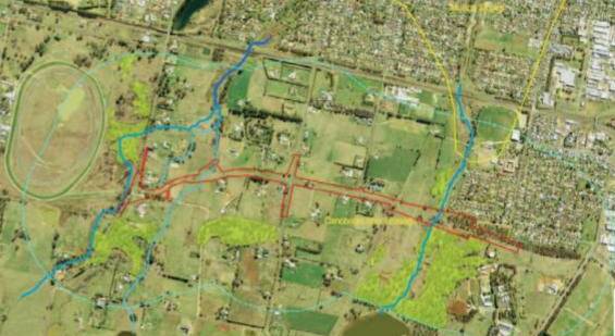 NEW ROAD: The path of the route going from Towac Park (left) to Jack Brabham Park (right) is shown in red on this aerial photo contained in the report.