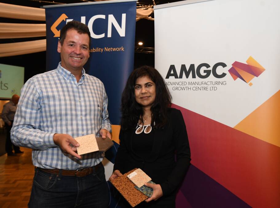 PRODUCTS: Business advisor Michael Sharpe and Professor Veena Sahajwalla with samples of walling made from recycled waste. Photo: JUDE KEOGH 0228jkwaste1