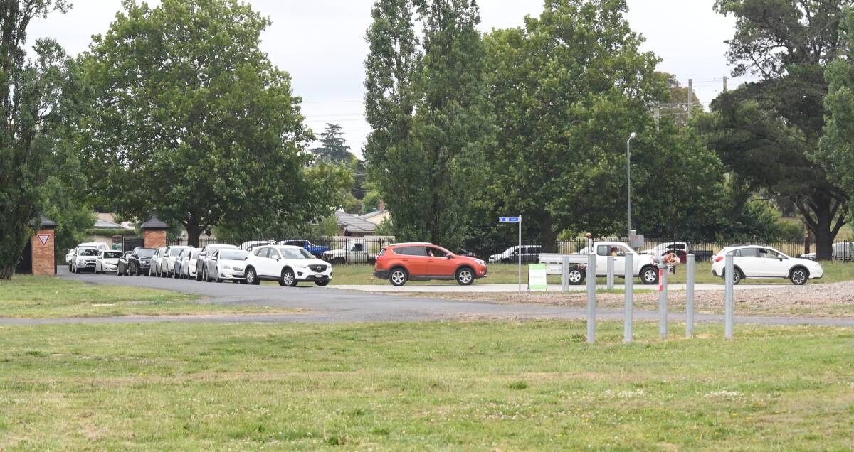 BUSY: Cars queued out onto Leeds Parade at the drive-through clinic at the Orange Showgrounds on Monday. Photo: CARLA FREEDMAN