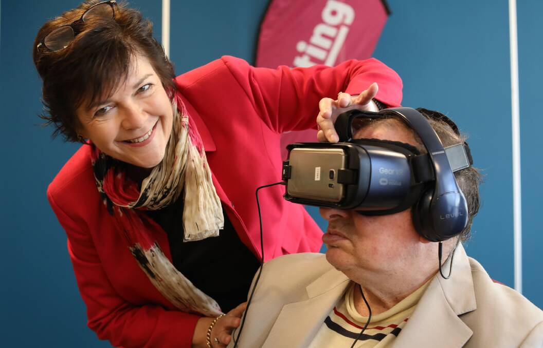 BUCKET LIST: Steve Cusack visits the Grand Canyon and Niagara Falls thanks to virtual reality and the help of Uniting executive director Tracey Burton. Photo: Supplied