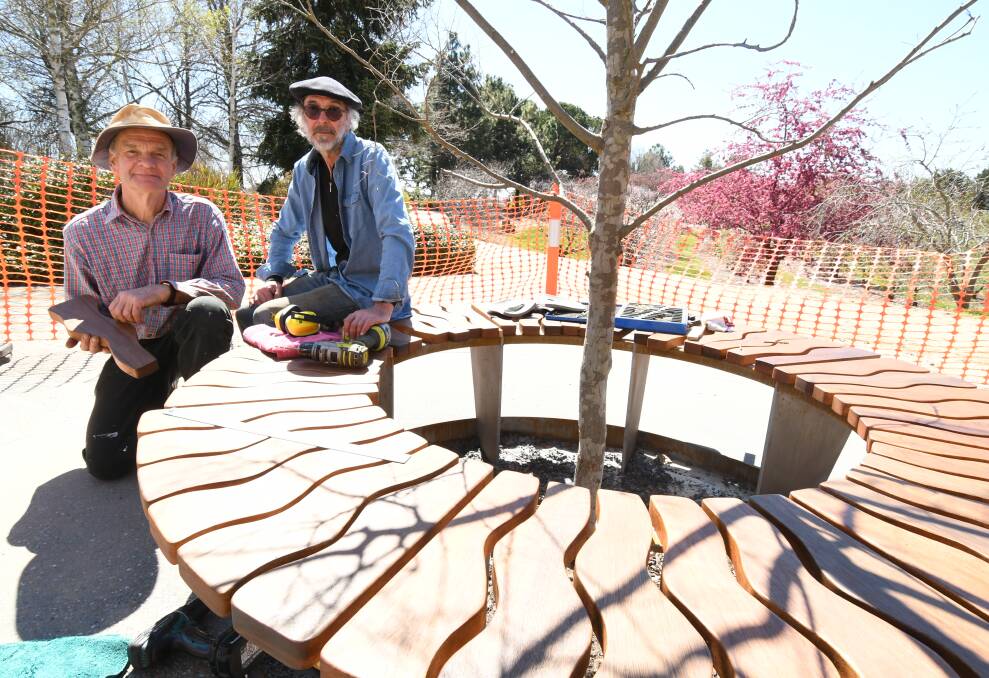 CREATORS: Geoff Tonkin and Tim Winters with the seat they have designed and built for the gardens' 30th anniversary. Photo: JUDE KEOGH 0927jkgardens2
