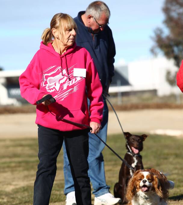 A DOG'S LIFE: Narelle Morgan and Bobby and Clint McGrath with Molly watched by instructor Isabel Holcombe at the dog obedience classes. Photo: PHIL BLATCH 0625pbdog1