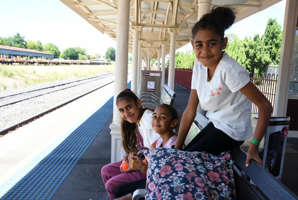 AT THE STATION: Crystal Edwards, Jenna-Lee Smith and Zuleika Edwards at Orange station on Sunday with the rail yard in the background. PHOTO: CARLA FREEDMAN