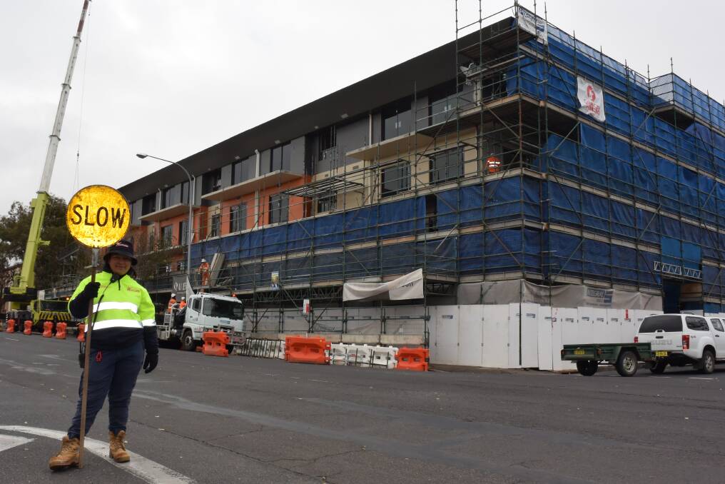AT WORK: Traffic controller Teawatere Tapine outside the Quest Apartments building on Kite Street on Monday. Photo: DAVID FITZSIMONS