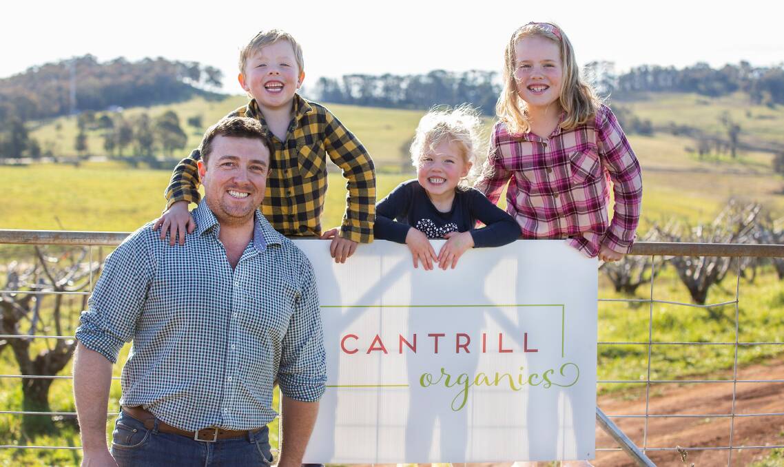 ORGANIC GROWTH: Luke Cantrill with his children Jack, Alannah and Ava on their Nashdale farm. Photo: Supplied