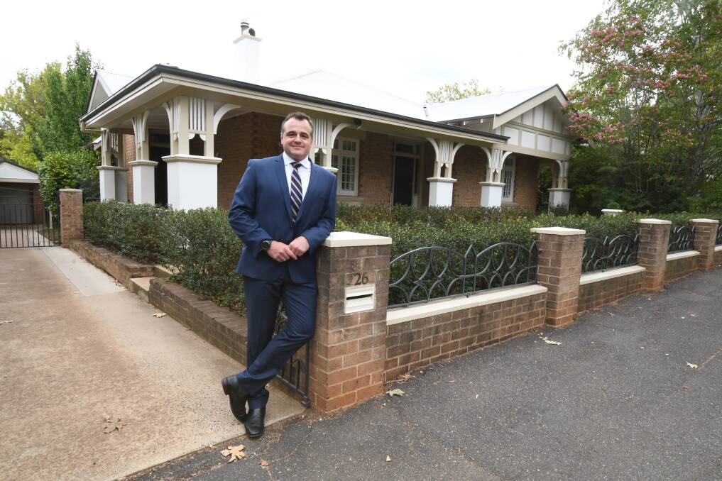 MILLION DOLLARS: Real estate agent Anthony Cook outside the latest Byng Street property to sell for more than $1 million. Photo: JUDE KEOGH