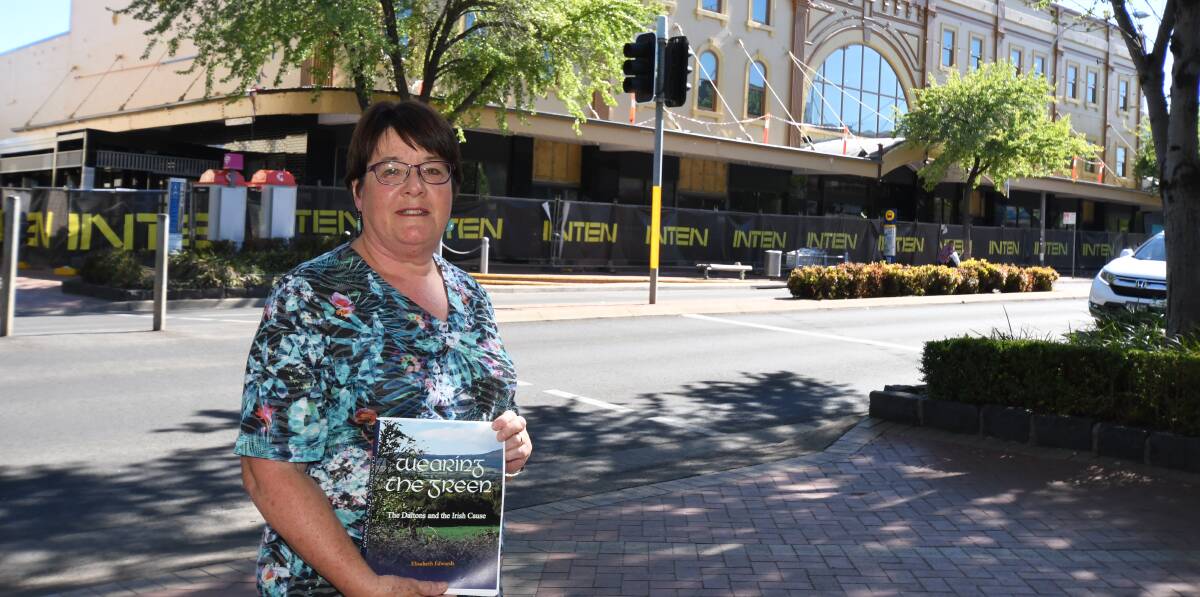 HOT OFF THE PRESS: Author Liz Edwards with her new book outside the former Dalton Stores building in Summer Street. Photo: CARLA FREEDMAN
