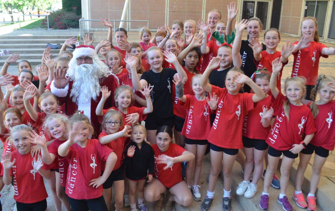 SEA OF RED: Santa joins Orange City Dance performers to welcome the Carols by Candlelight back to town. Photo: DAVID FITZSIMONS 1203dfsanta1