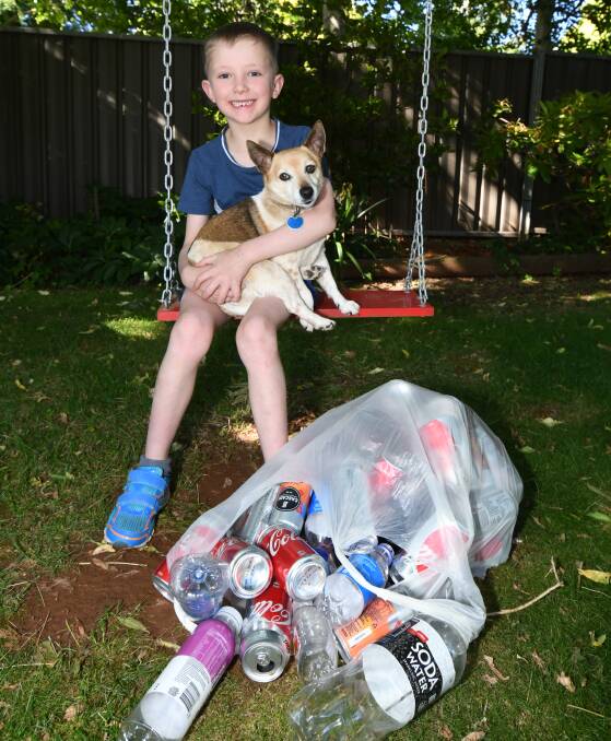SUCCESS: Charlie McLaughlin with his family's dog Bonnie after his recycling efforts have raised more than $200. Photo: CARLA FREEDMAN 1129cfrecycle4