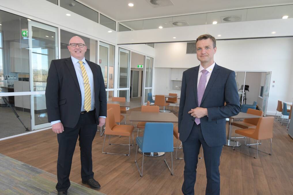 OPENING: Dudley Private Hospital CEO Paul McKenna with clinical director Dr Tristram Duncan in the therapy/lounge room of the new wing. Photo: JUDE KEOGH