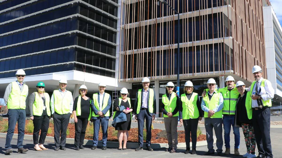 MOVING IN: David Bedwell, Catherine Gordon, Adam Browne, Professor Heather Cavanagh, Professor John Germov, Cassandra Webeck, vice-chancellor Professor Andrew Vann, Paul Dowler, and Jenny Roberts with the site's developers including Frank OHalloran (fourth from right) and Mr Garry Zauner (right) at the Bloomfield Private Medical Centre. Photo: Supplied