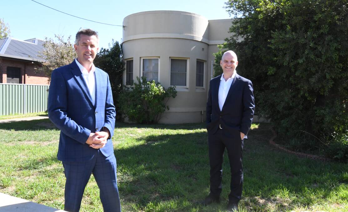 SOLD: One Agency real estate director Ash Brown and assistant Roger Burrell at one of the unique P&O-style houses that have been sold on Bathurst Road. Photo: JUDE KEOGH