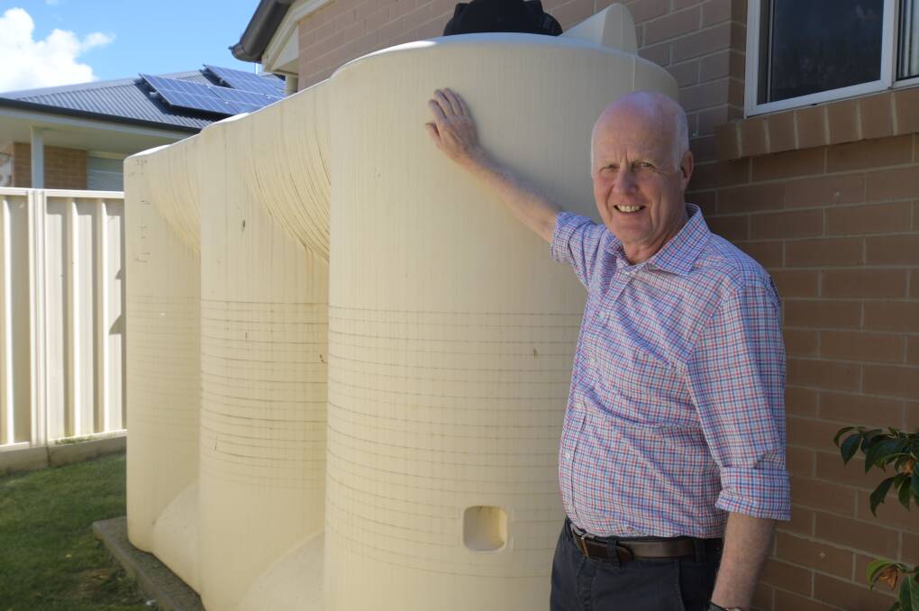 IN RESERVE: ECCO president Neil Jones with the rainwater tank at his Orange property. Photo: JUDE KEOGH