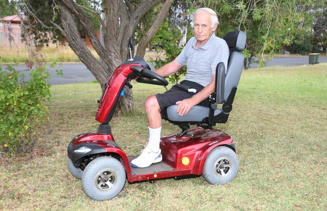 UPSET: Pensioner Ron Hall on his mobility scooter that was stolen, taken for a joyride and damaged by three young men on Saturday morning. Photo: CARLA FREEDMAN 0107cfscooter1 